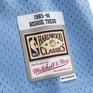 MITCHELL & NESS REGGIE THEUS 1985-86 BLUE SWINGMAN JERSEY